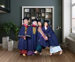 UITM Degree graduates wearing convocation robe with one of them wearing selempang anugerah naib canselor, with modern contemporary living room with beautiful bookshelf UITM Degree graduates wearing convocation robe with one of them wearing selempang anugerah naib canselor, with modern contemporary living room with beautiful bookshelf